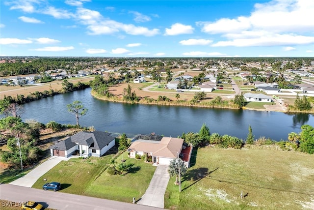 drone / aerial view featuring a water view and a residential view