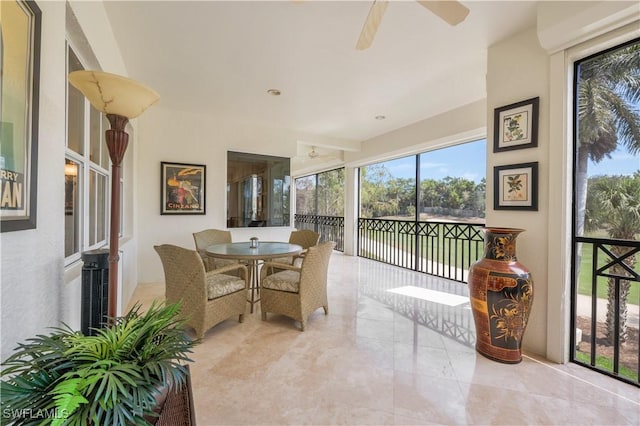 sunroom featuring a ceiling fan