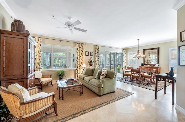 living area with ceiling fan with notable chandelier and ornamental molding