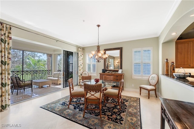 dining area featuring crown molding, baseboards, and a notable chandelier