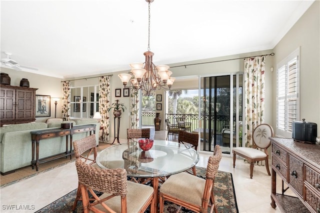 dining space with ornamental molding, light tile patterned floors, plenty of natural light, and ceiling fan with notable chandelier