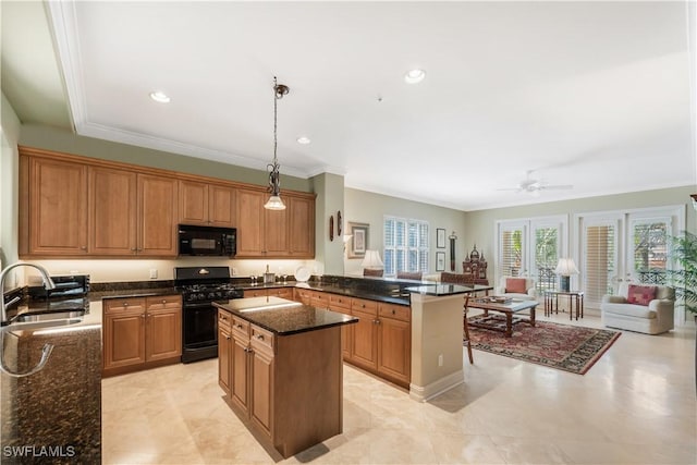 kitchen with a peninsula, a sink, a center island, black appliances, and crown molding