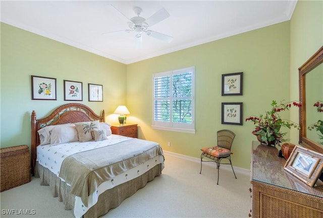 carpeted bedroom featuring baseboards, ornamental molding, and a ceiling fan