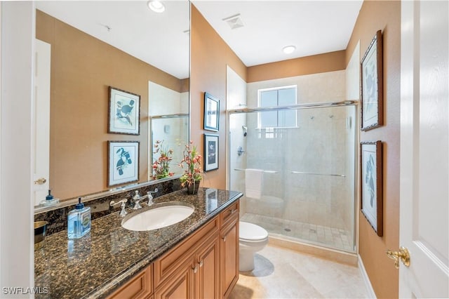 bathroom featuring toilet, a stall shower, and vanity