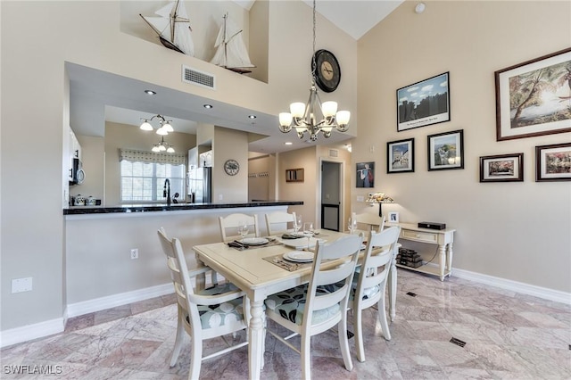 dining room with sink and an inviting chandelier