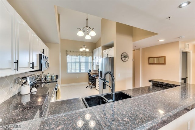 kitchen featuring white cabinetry, sink, hanging light fixtures, an inviting chandelier, and appliances with stainless steel finishes