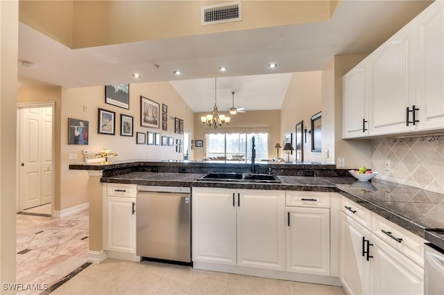 kitchen with dishwasher, lofted ceiling, white cabinets, sink, and a chandelier