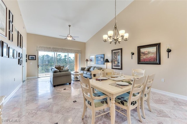 dining space with ceiling fan with notable chandelier and high vaulted ceiling