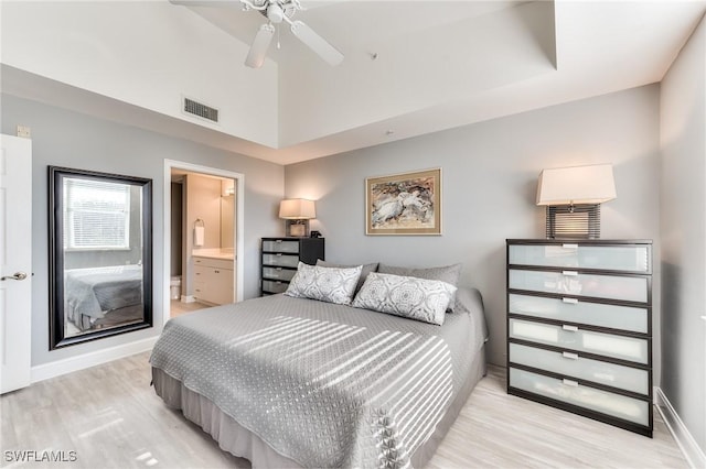 bedroom with light wood-type flooring, connected bathroom, and ceiling fan