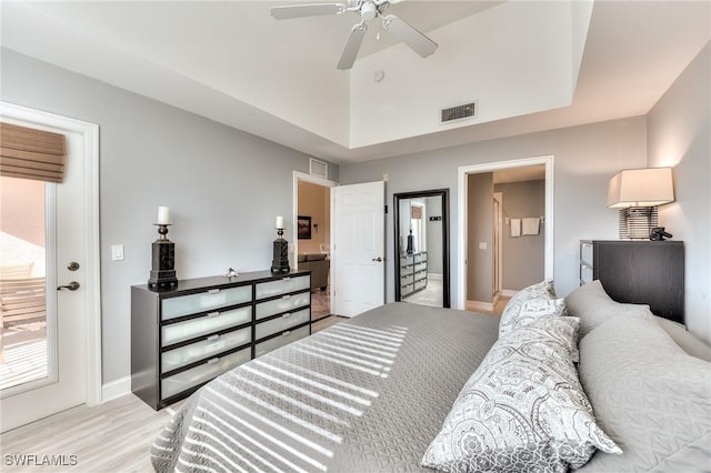 bedroom with connected bathroom, light hardwood / wood-style flooring, and ceiling fan