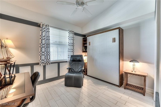 sitting room featuring ceiling fan, light hardwood / wood-style flooring, and vaulted ceiling