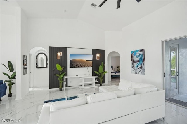 living room with ceiling fan and high vaulted ceiling