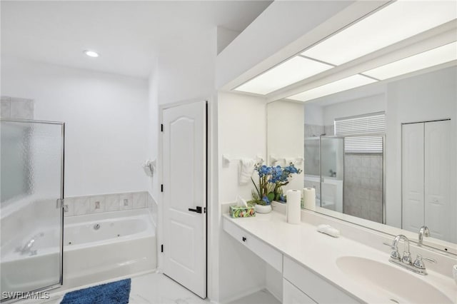 bathroom featuring shower with separate bathtub and vanity