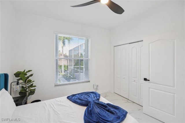 bedroom featuring ceiling fan and a closet