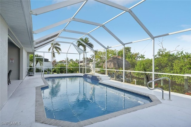 view of pool with a lanai and a patio