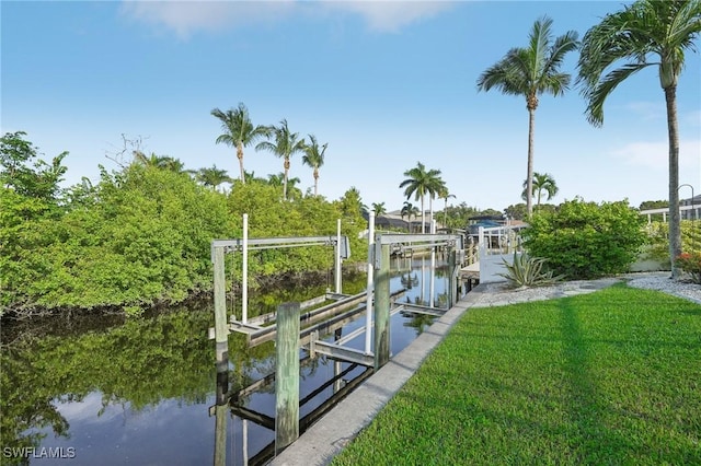 dock area featuring a water view and a yard