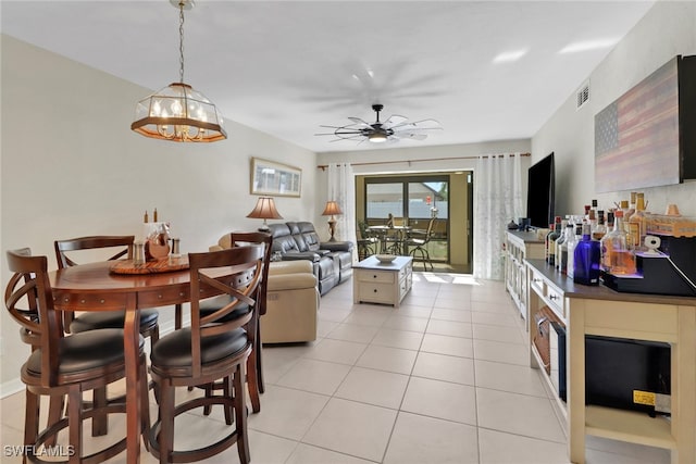 interior space featuring ceiling fan with notable chandelier