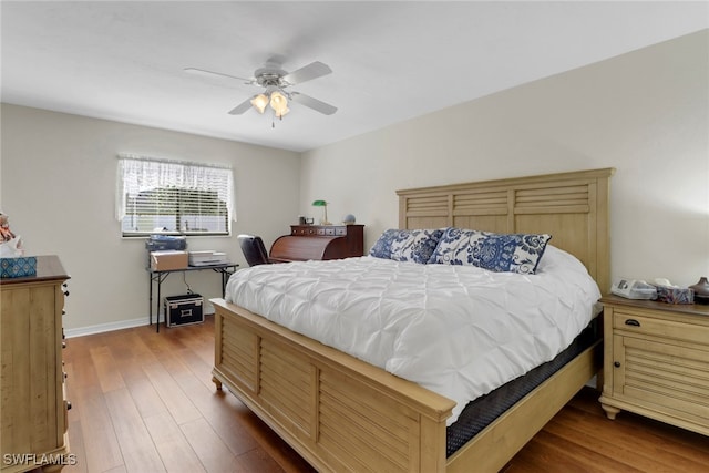 bedroom featuring dark hardwood / wood-style flooring and ceiling fan