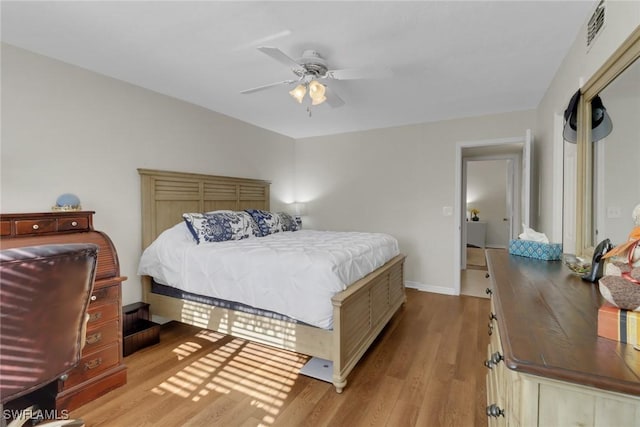 bedroom with ceiling fan and light hardwood / wood-style flooring