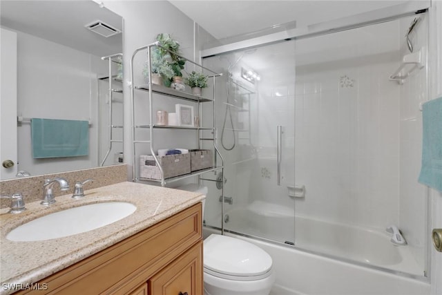 full bathroom with vanity, enclosed tub / shower combo, and toilet