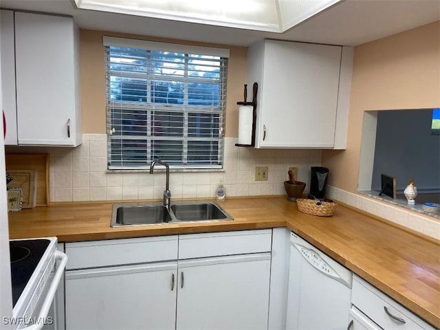 kitchen featuring white cabinetry, dishwasher, sink, backsplash, and stove