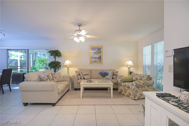 living room with ceiling fan and light tile patterned floors