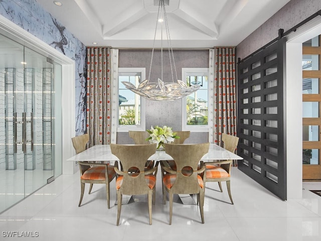 dining space featuring an inviting chandelier and a barn door