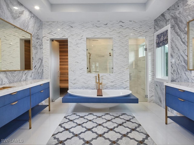 bathroom with shower with separate bathtub, tile patterned floors, and vanity