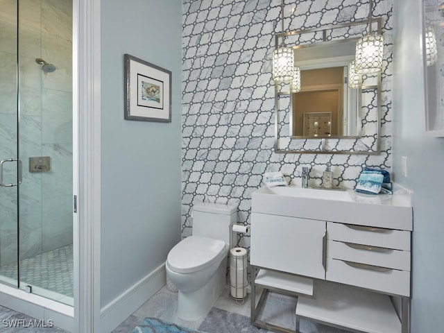 bathroom featuring vanity, toilet, decorative backsplash, and a shower with shower door