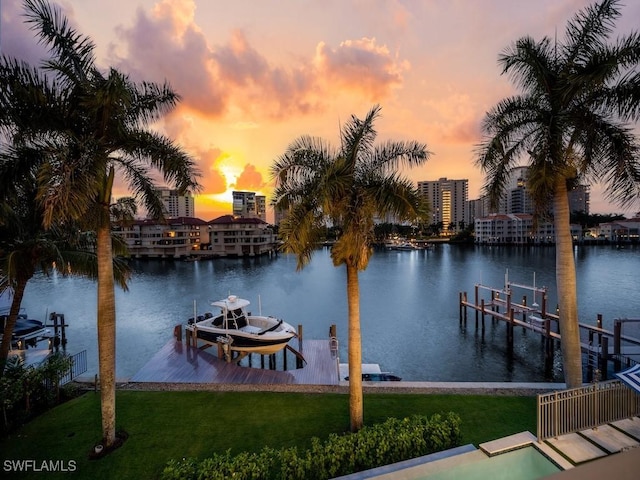 view of dock with a water view and a lawn