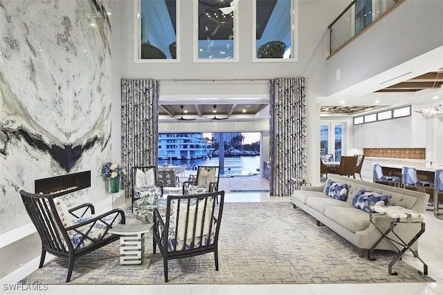 living room featuring a high ceiling and a premium fireplace