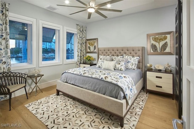 bedroom with light hardwood / wood-style floors and ceiling fan