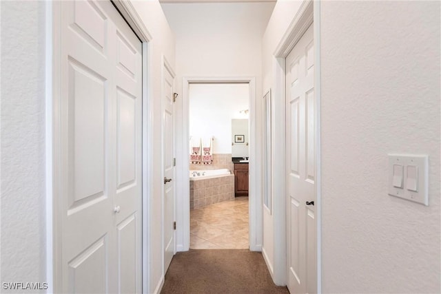 corridor with light tile patterned flooring