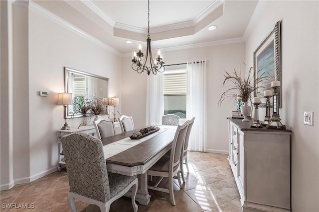 tiled dining area with a notable chandelier, a raised ceiling, and crown molding