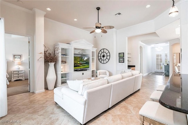 living room featuring ceiling fan and crown molding