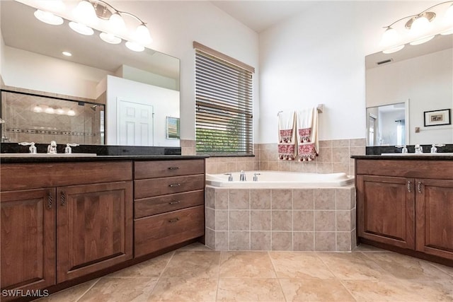 bathroom with tile patterned floors, vanity, and independent shower and bath