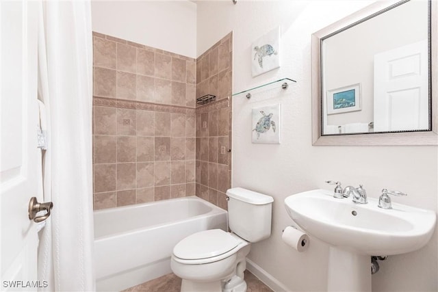 full bathroom with tiled shower / bath combo, toilet, and sink