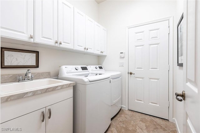 clothes washing area with cabinets, light tile patterned flooring, washer and clothes dryer, and sink