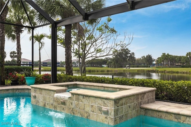 view of pool with an in ground hot tub, a water view, and glass enclosure