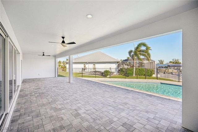 view of swimming pool featuring ceiling fan and a patio area