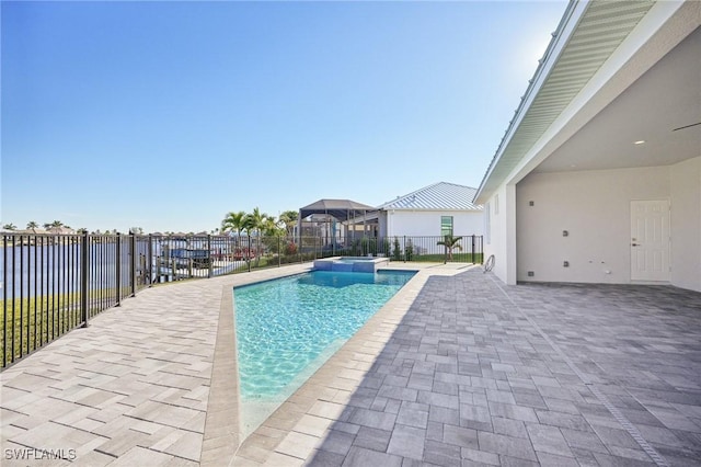 view of swimming pool with a patio and a water view