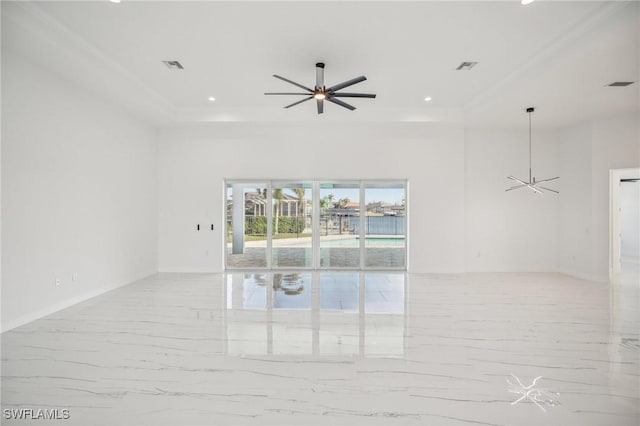 empty room featuring a raised ceiling and ceiling fan