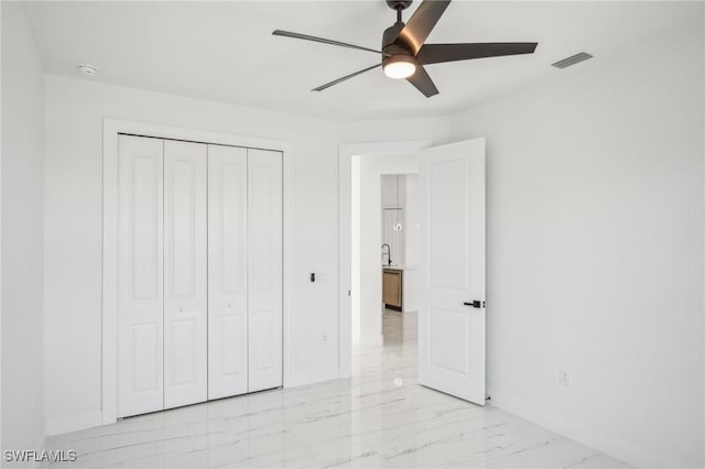 unfurnished bedroom featuring a closet and ceiling fan