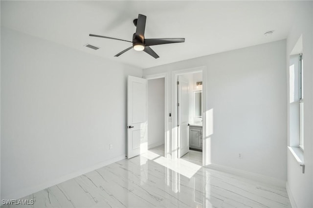 unfurnished bedroom featuring ensuite bath and ceiling fan