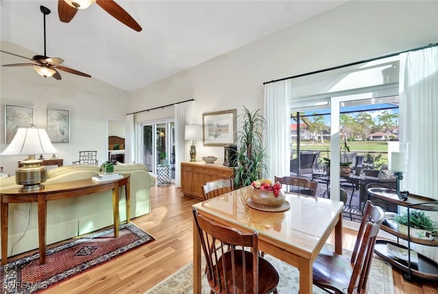 dining space featuring light hardwood / wood-style floors and lofted ceiling