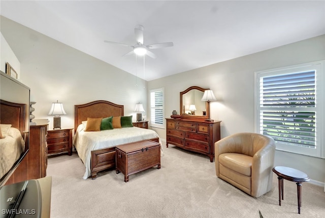 carpeted bedroom featuring ceiling fan and vaulted ceiling