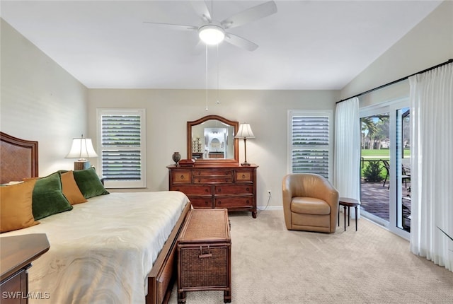 carpeted bedroom featuring ceiling fan, lofted ceiling, and access to outside