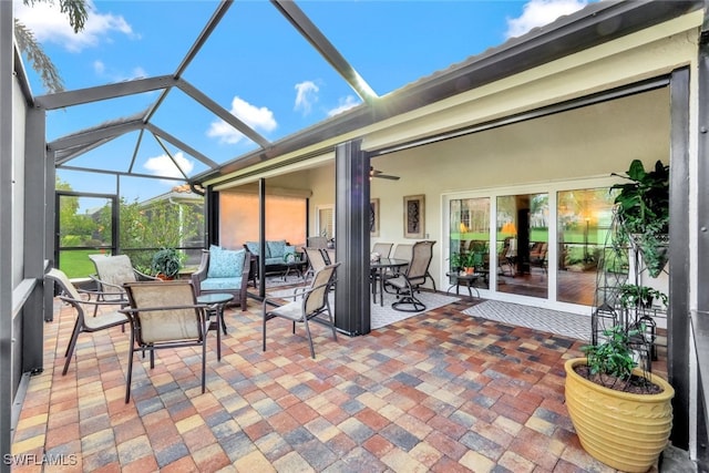 view of patio / terrace featuring glass enclosure and ceiling fan