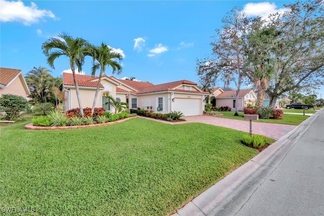 mediterranean / spanish-style house with a garage and a front lawn