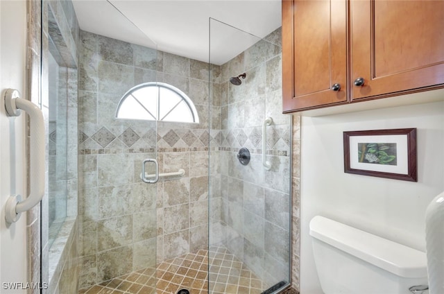 bathroom with an enclosed shower and toilet